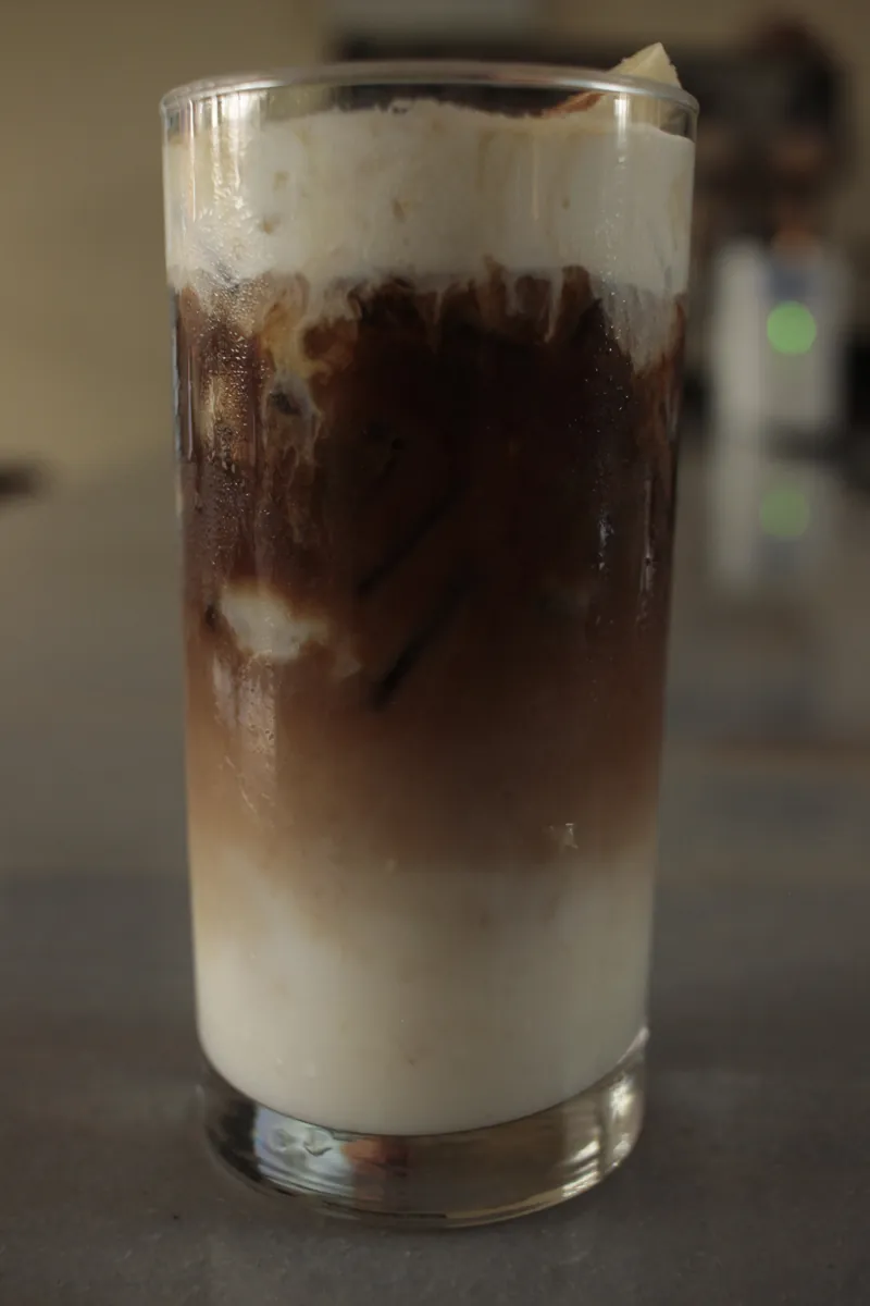 Layered iced latte in a tall glass